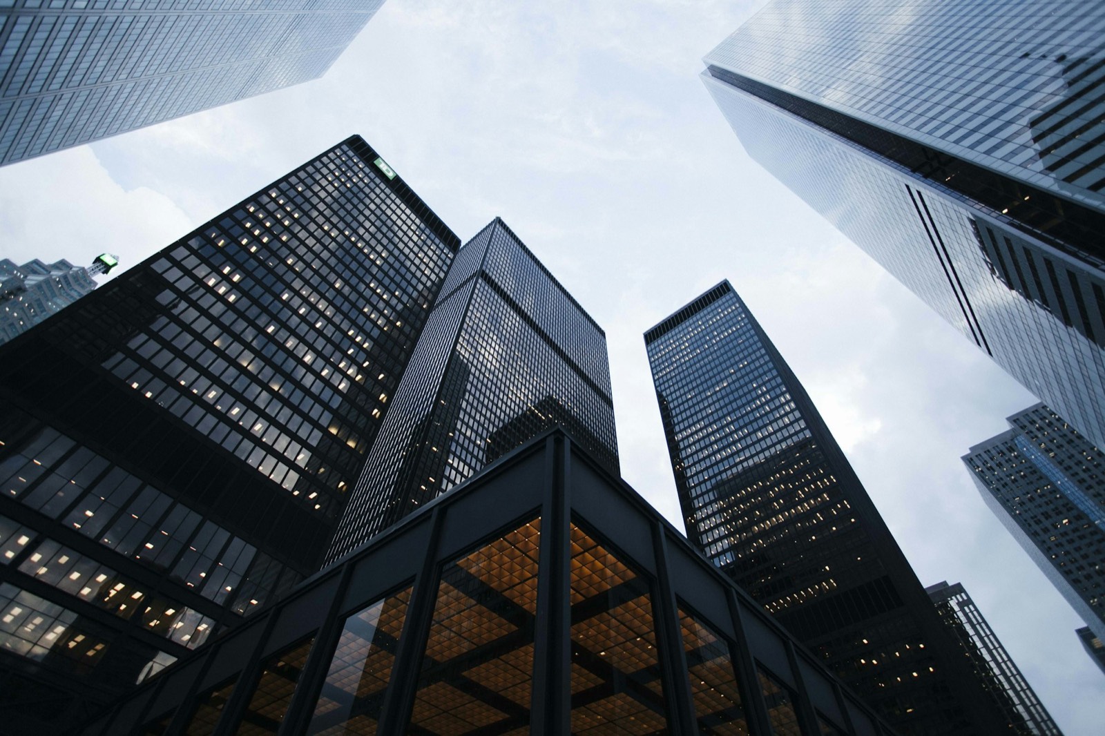 Glass commercial towers seen from street level. Illustrative photograph, not a company project.