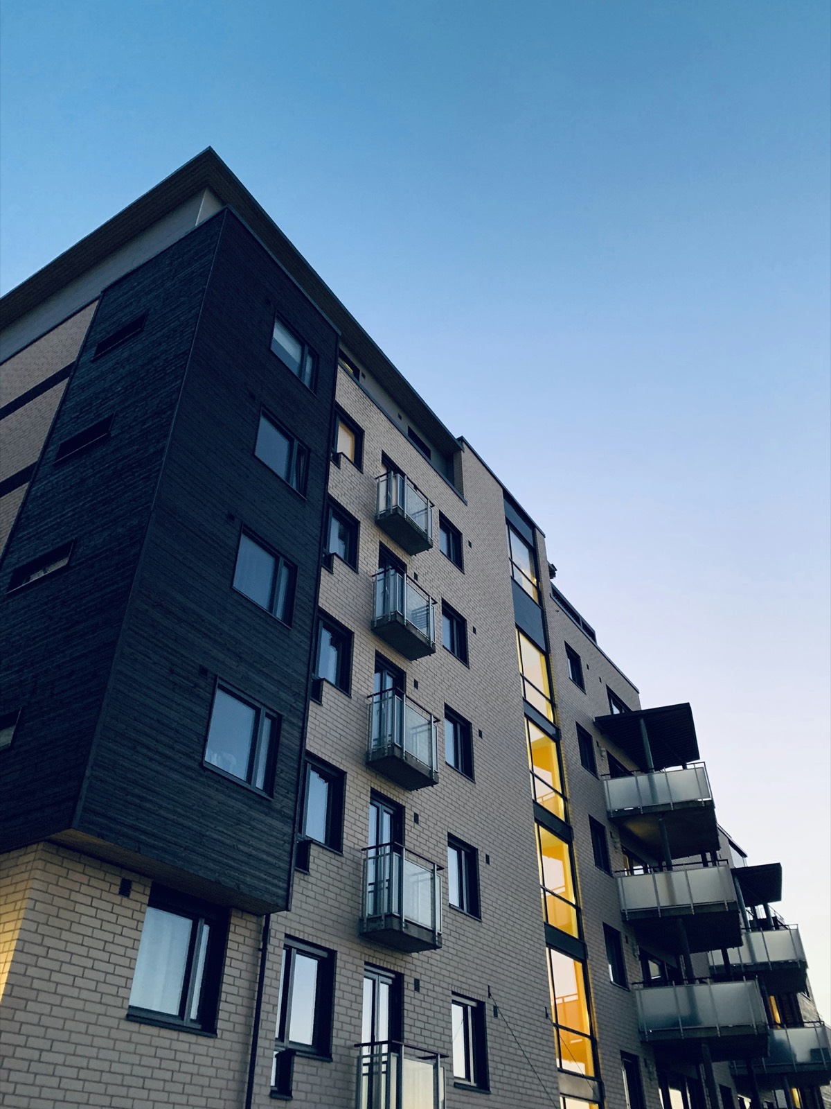 A brick and timber residential block with balconies. Illustrative photograph, not a company project.